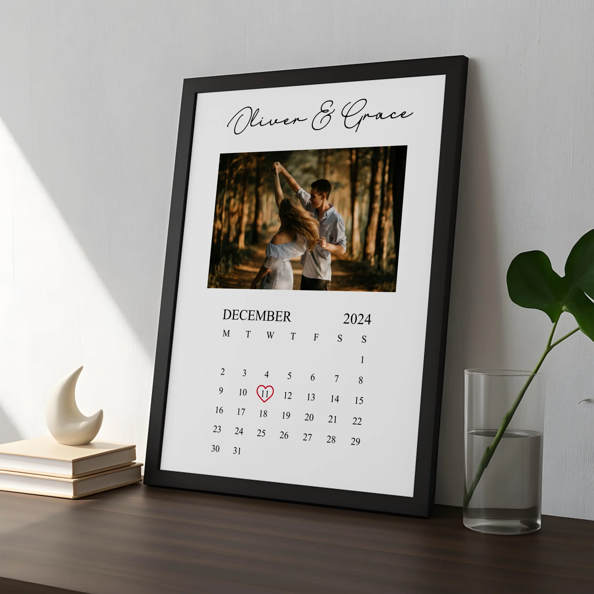 Front view of personalised photo calendar print in white frame with custom details