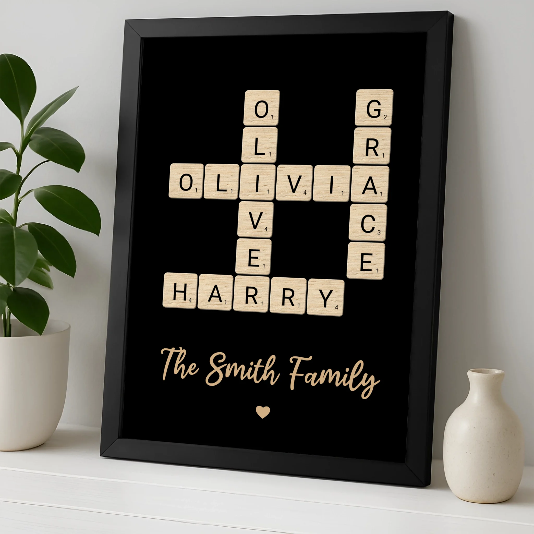 Personalised crossword wall art showing family names arranged in a grid, presented in a framed gift