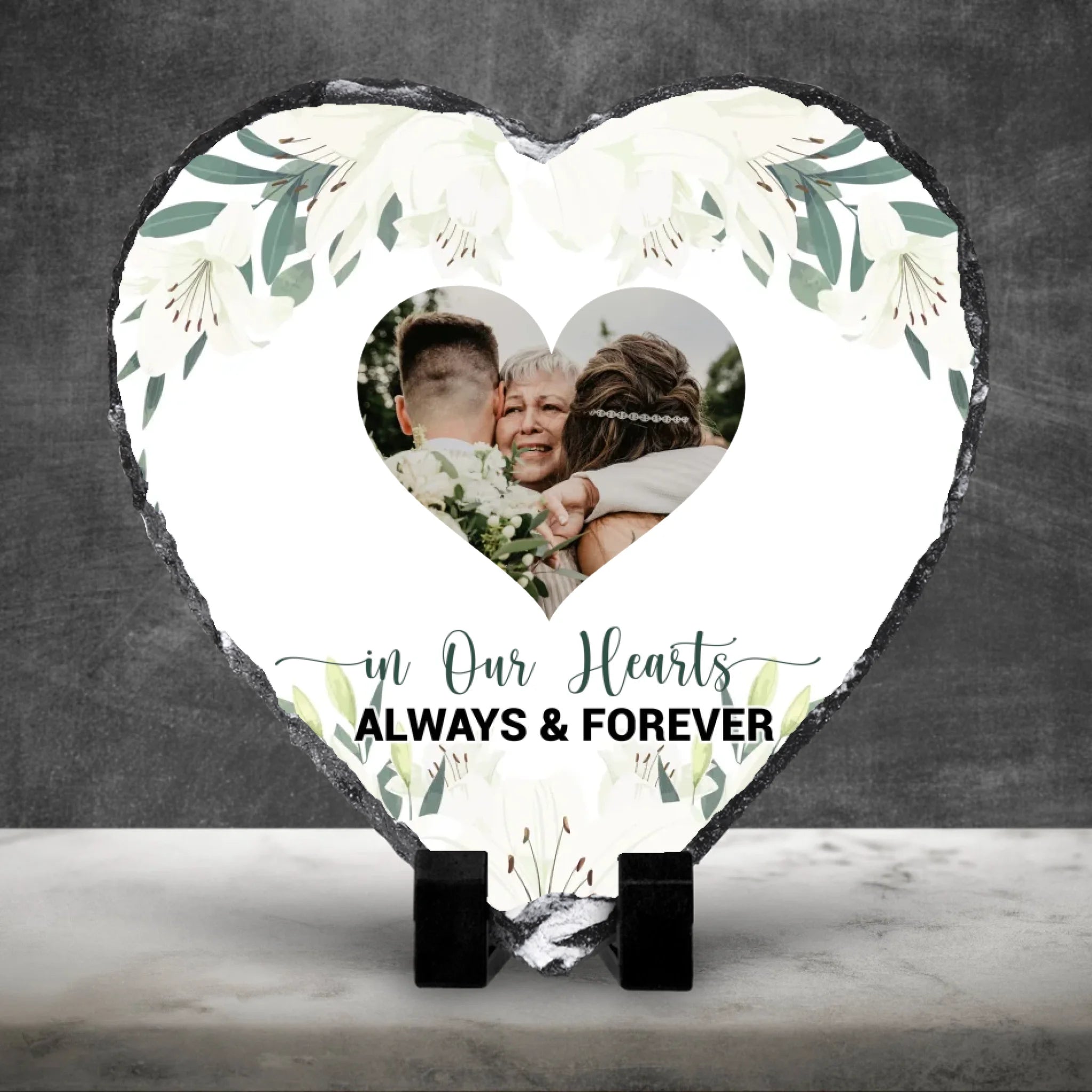 Personalised memorial photo slate on a white marble surface against a dark wall