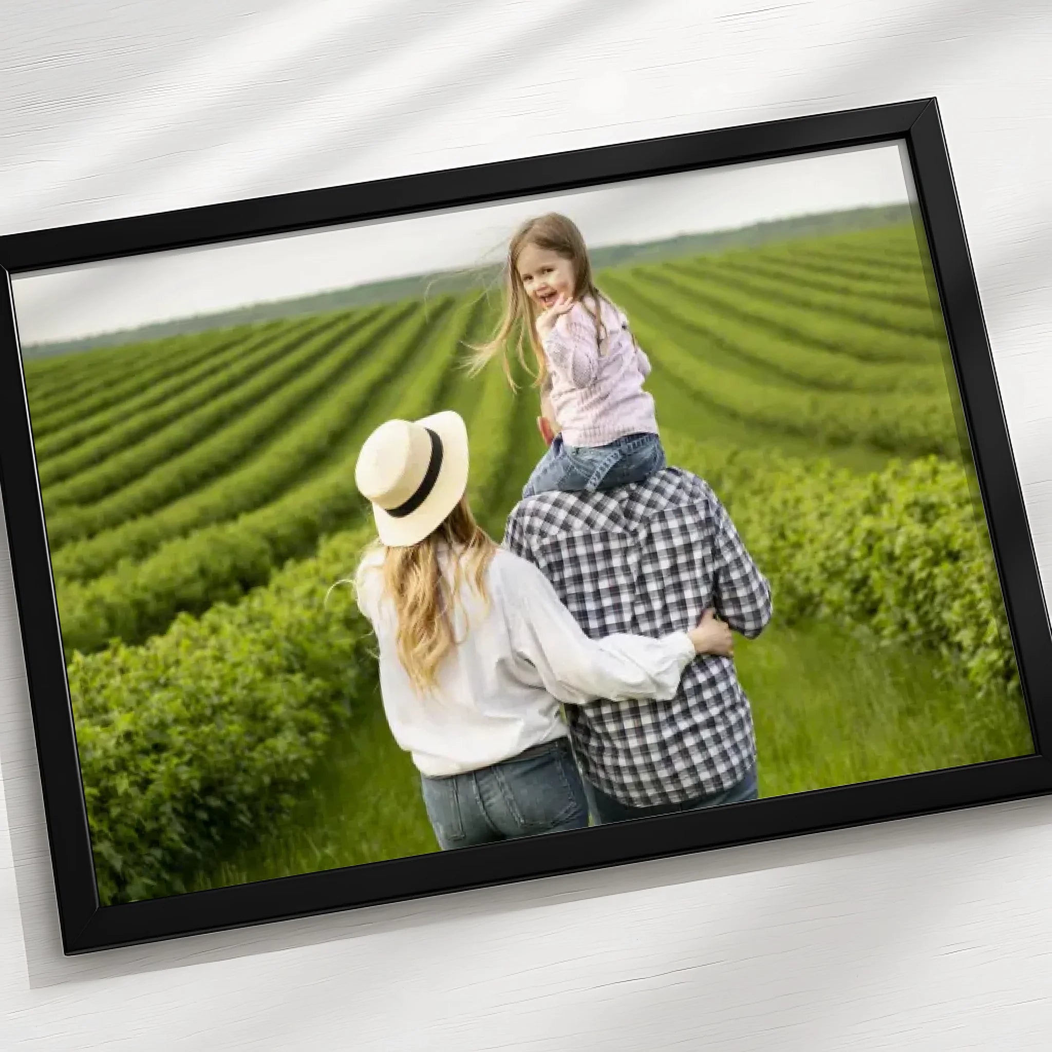 Personalised photo frame leaning against a wall in a home setting