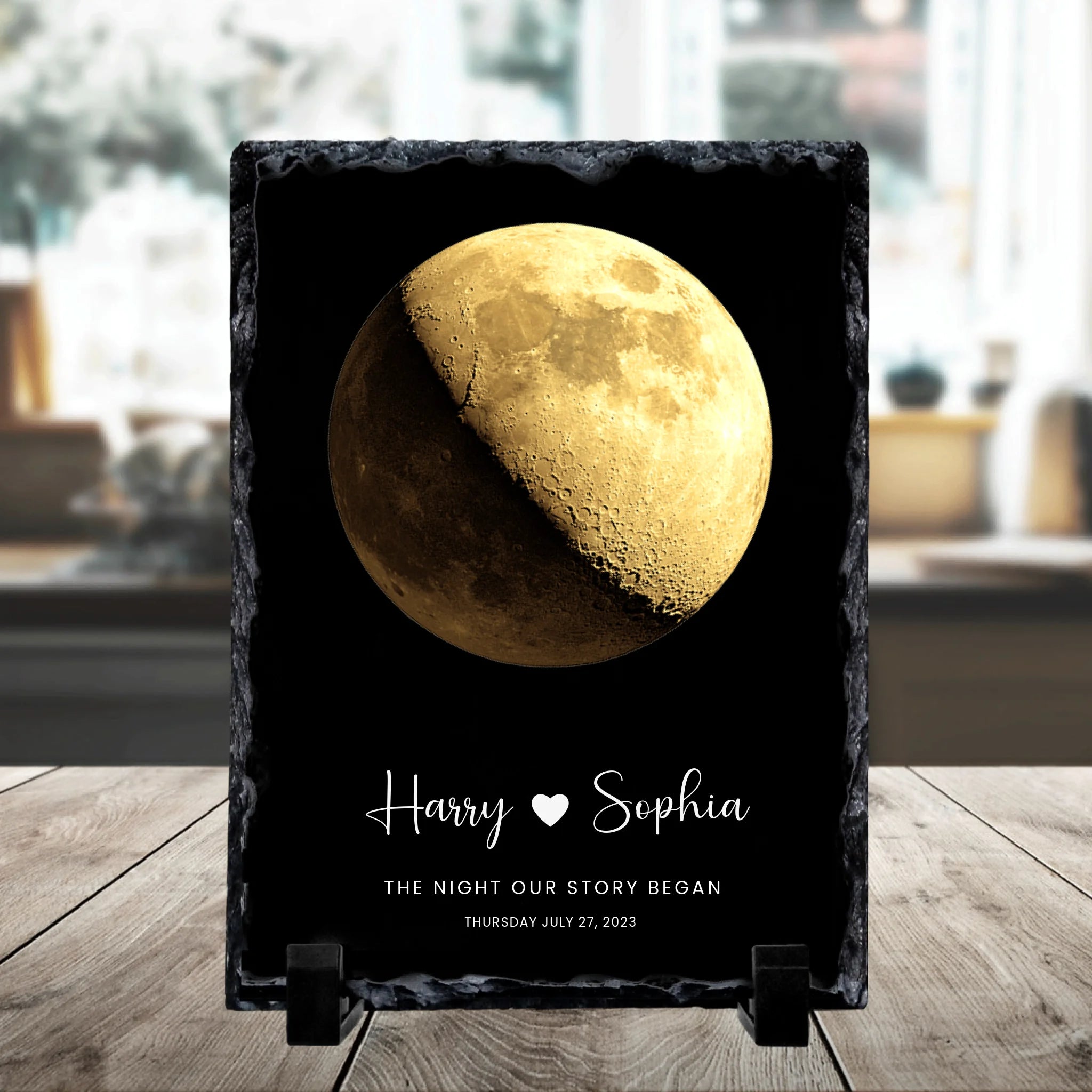 Personalised moon phase slate plaque on a stand with a gold gibbous moon, names Harry and Sophia, and date Thursday July 27 2