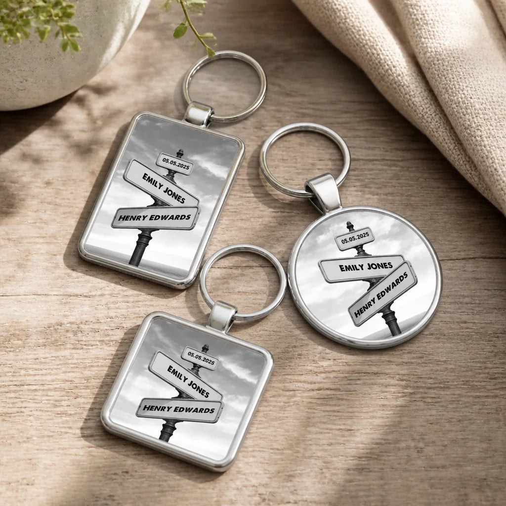 Three silver keyrings in round, square and rectangular shapes, each showing a black and white vintage street sign personalise