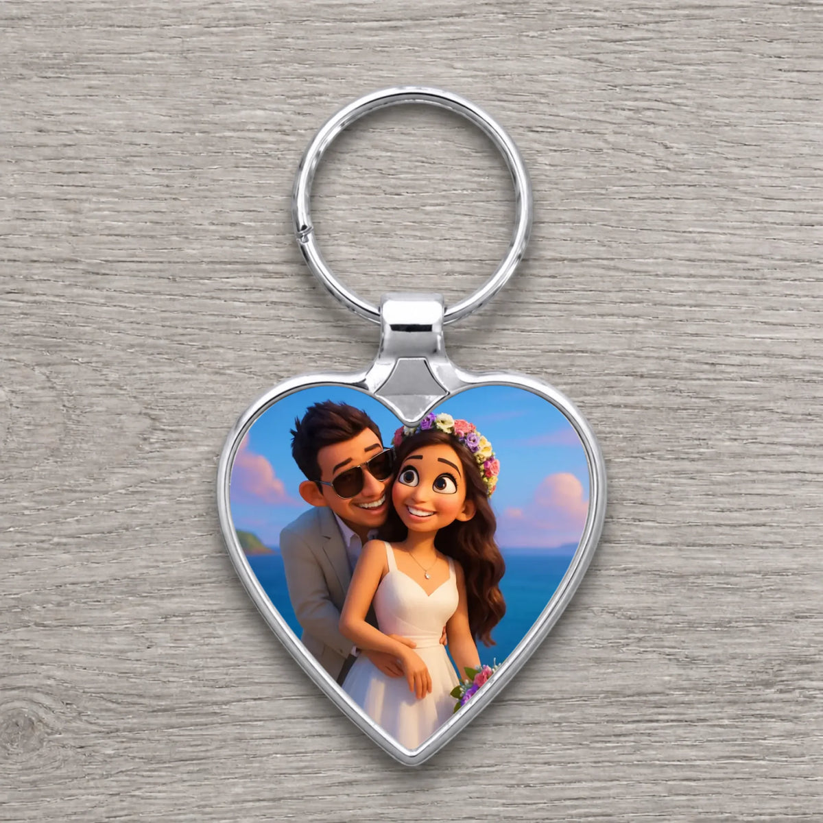 Silver heart-shaped keyring with cartoon animated bride in floral crown and groom in sunglasses embracing by the sea.