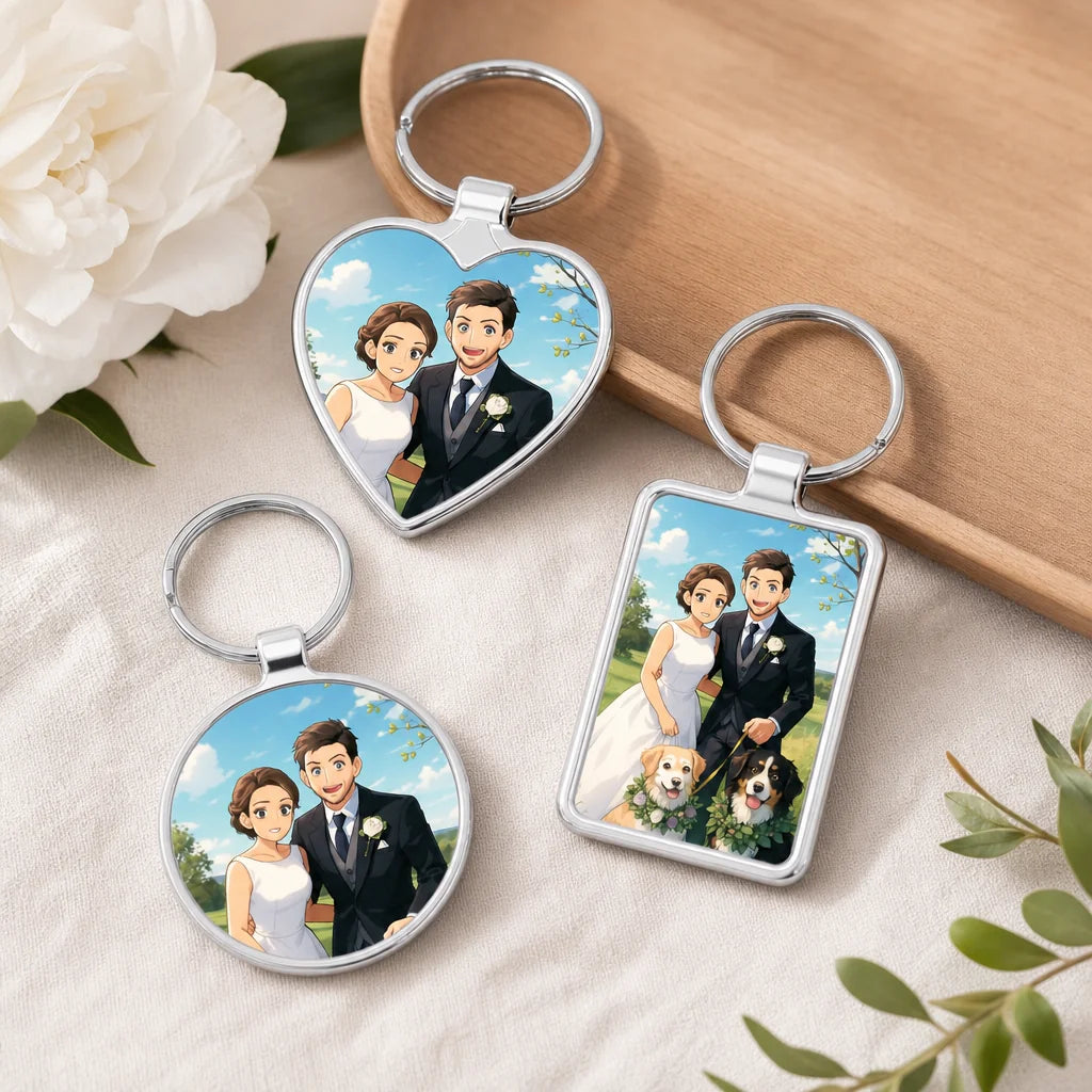 Three silver keyrings in heart, round and rectangle shapes, each printed with an anime cartoon wedding couple and two dogs ou