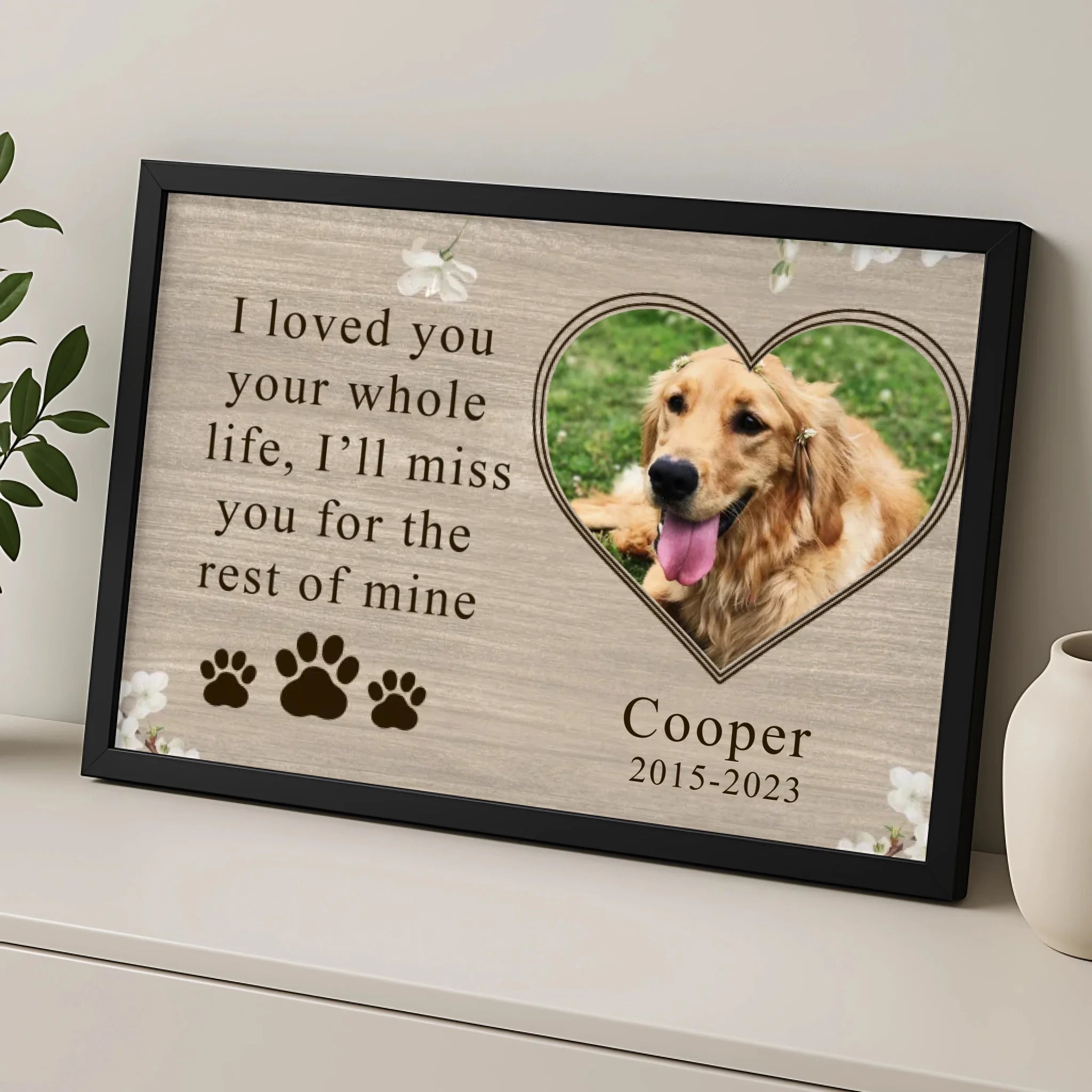 Close-up of personalised pet memorial photo frame with custom text and pawprints