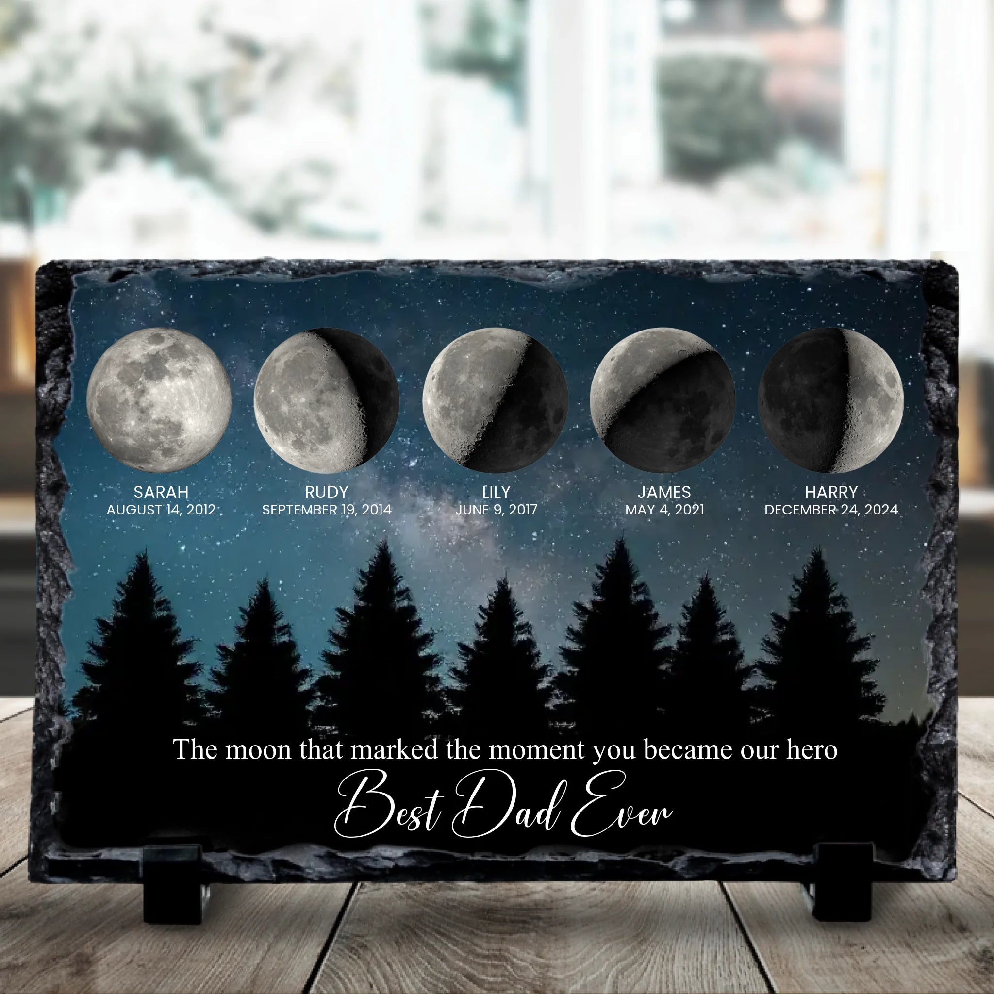 Close-up of a custom photo slate featuring a night sky moon phase print, personalised for a family