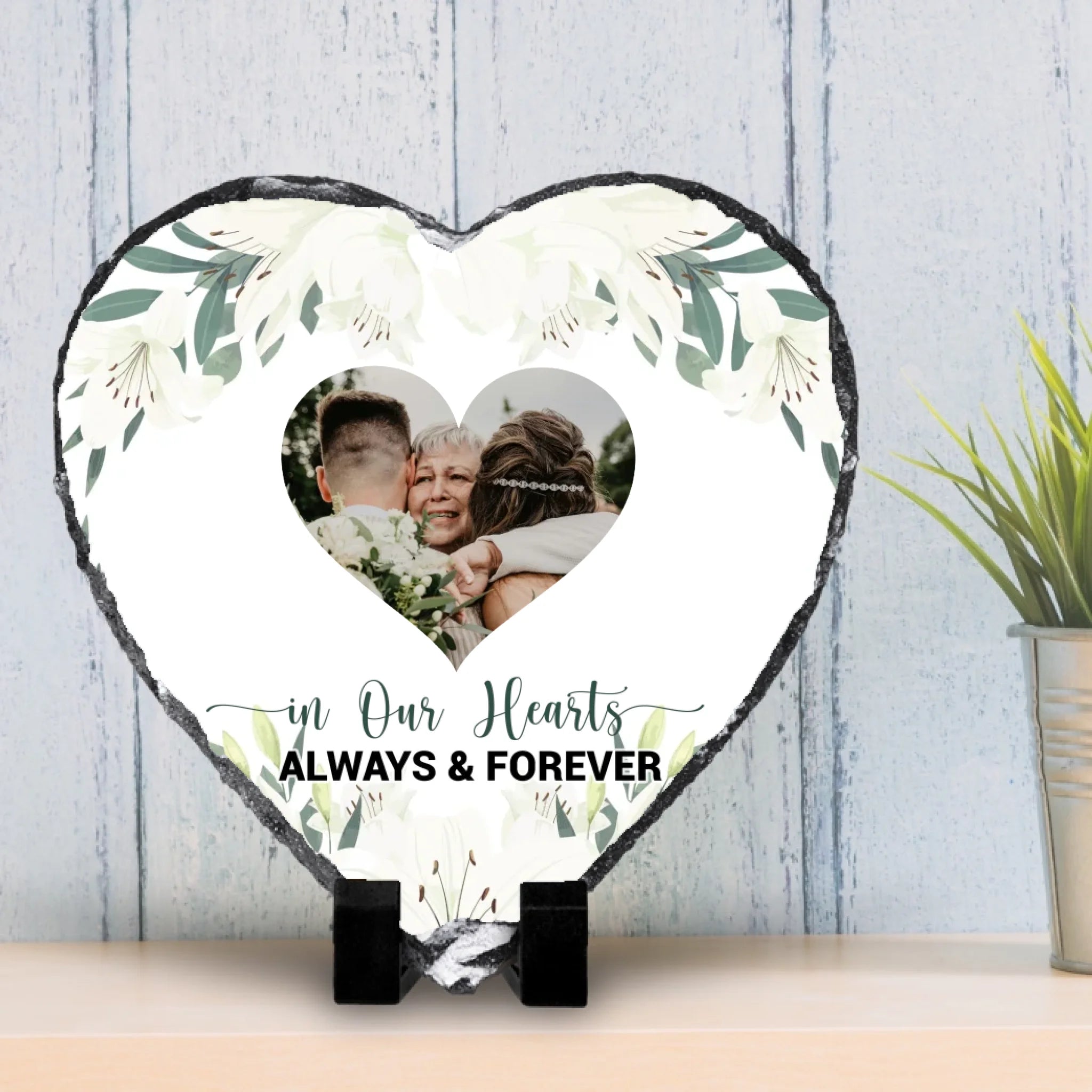 Floral memorial photo slate shown beside a vase of flowers as a home decoration