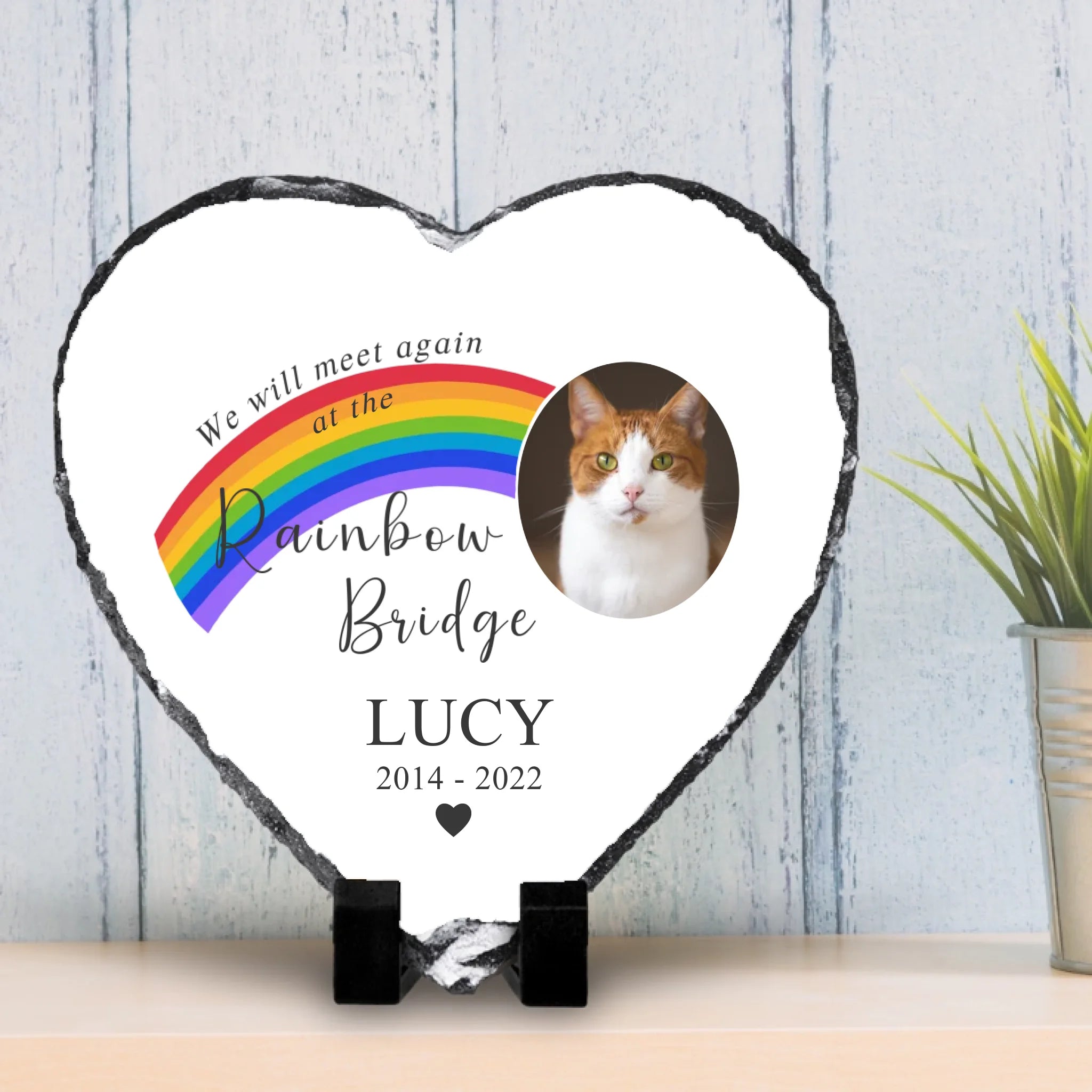Heart shaped personalised photo slate displayed near a vase with flowers as home decor