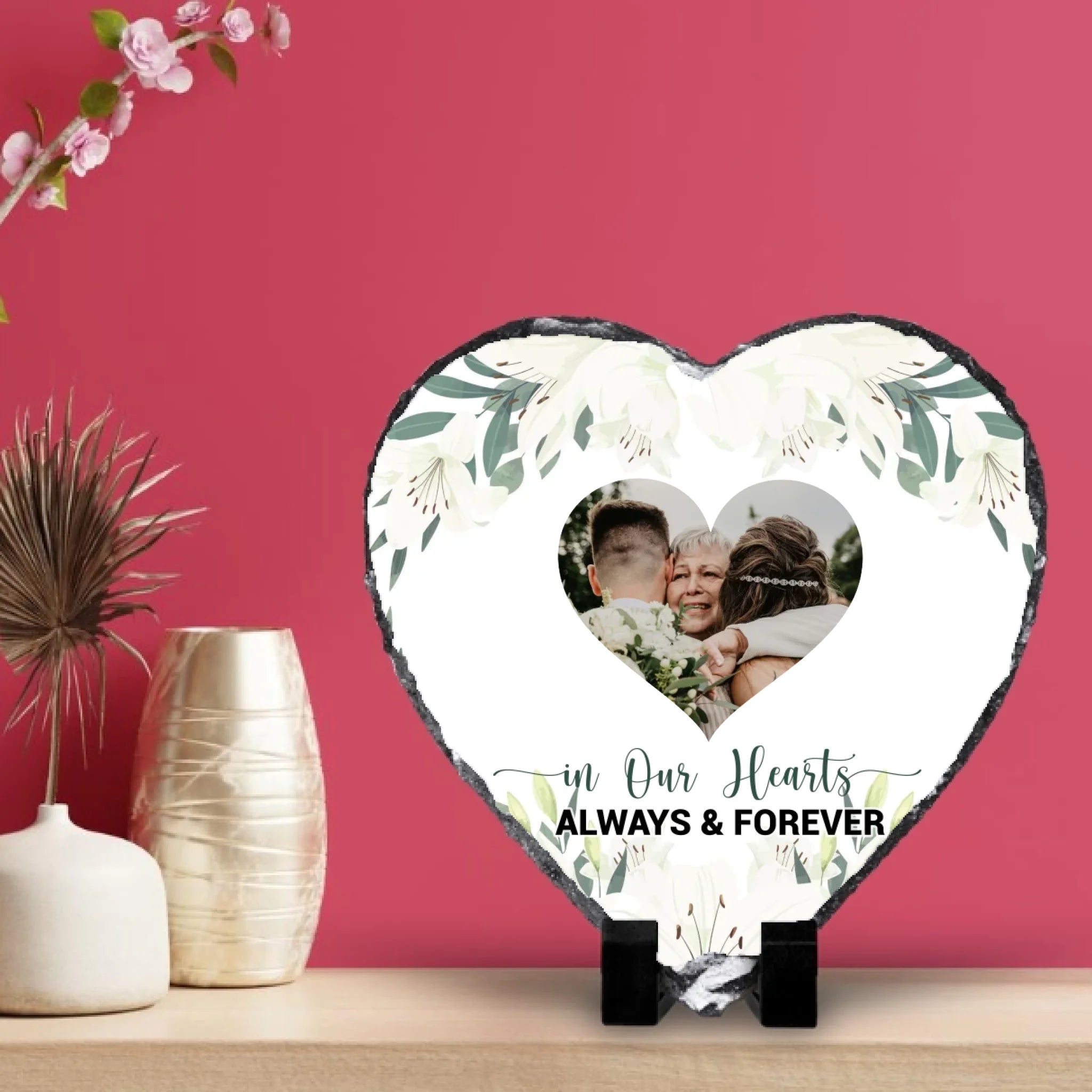 Custom heart shaped photo slate on a wooden shelf against a magenta panelled wall