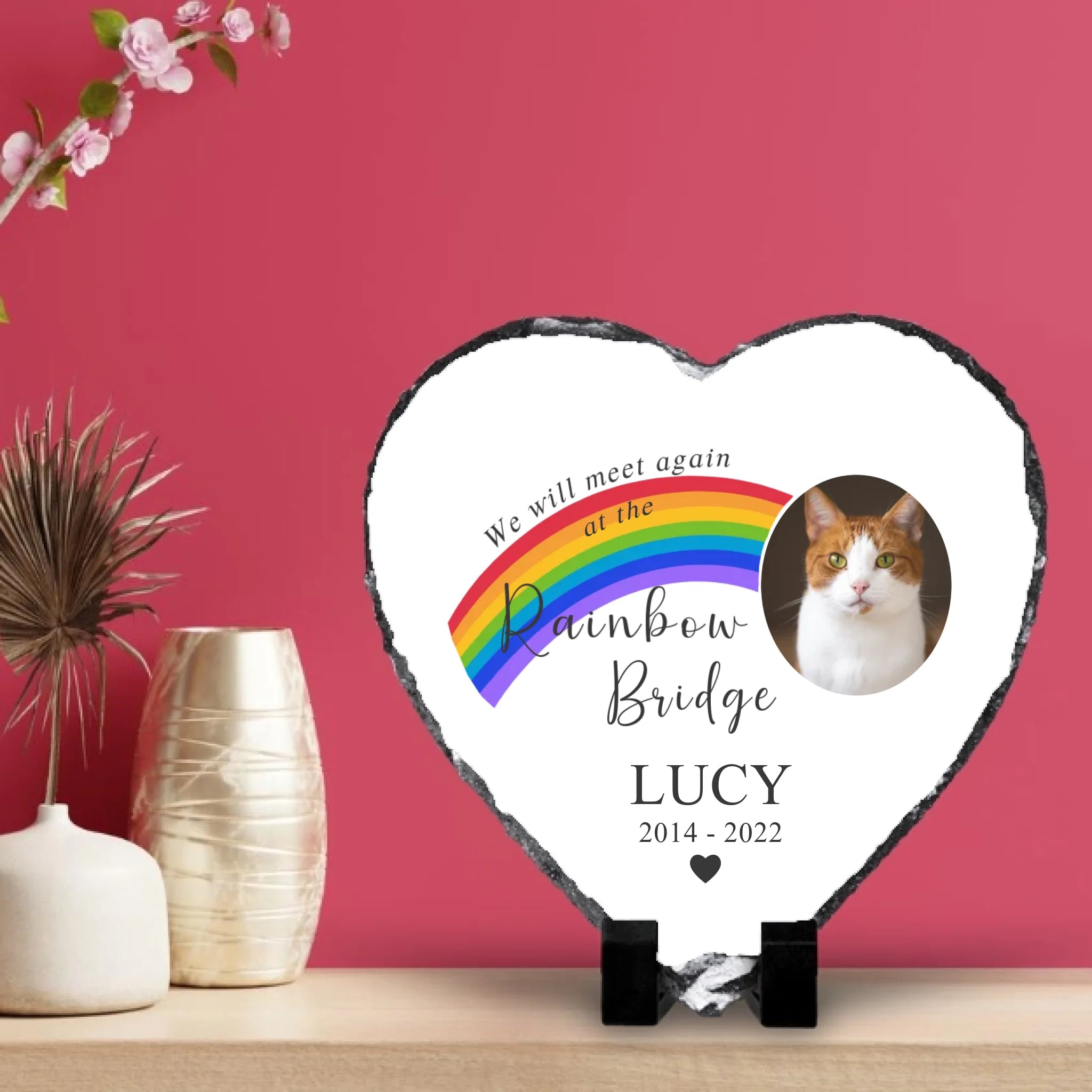 Custom pet memorial photo slate on a wooden shelf against a pink wall