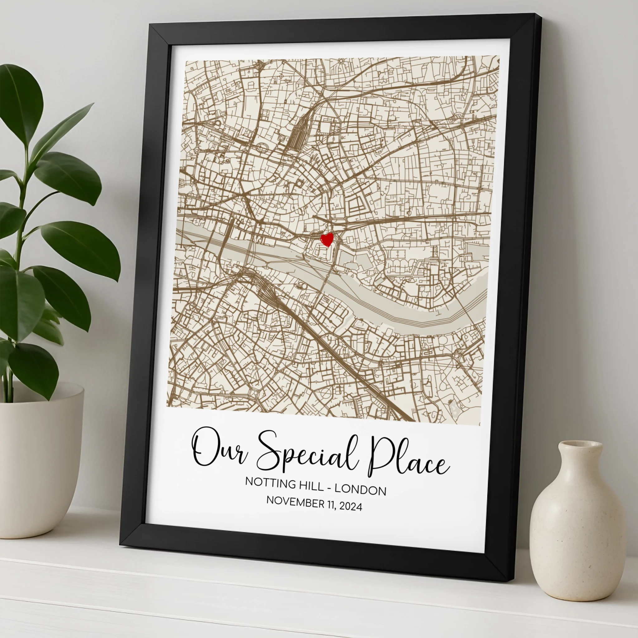 Custom location map print in a white frame showing personalised names and heart marker