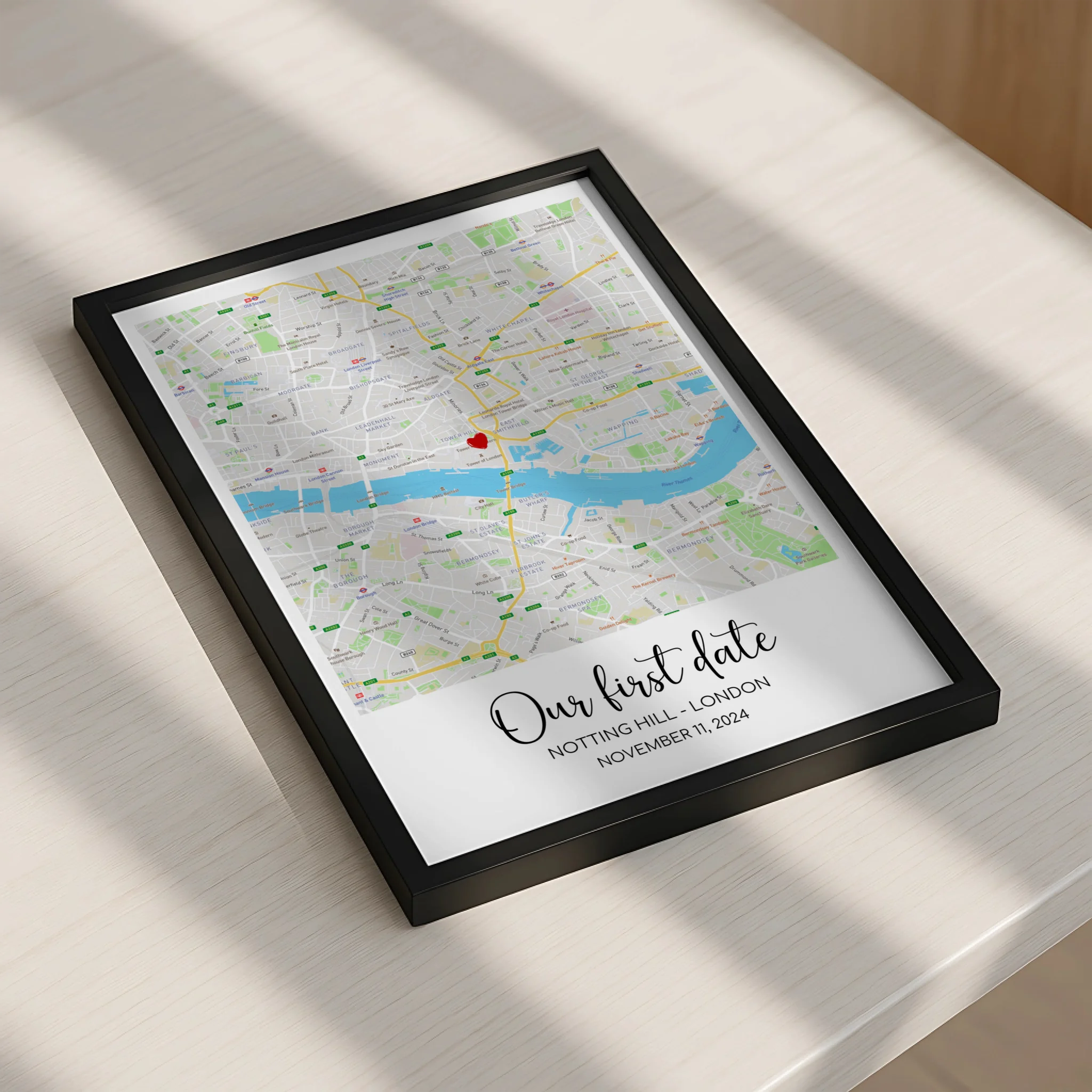 A3 personalised map print with heart marker and couple's names displayed on wall