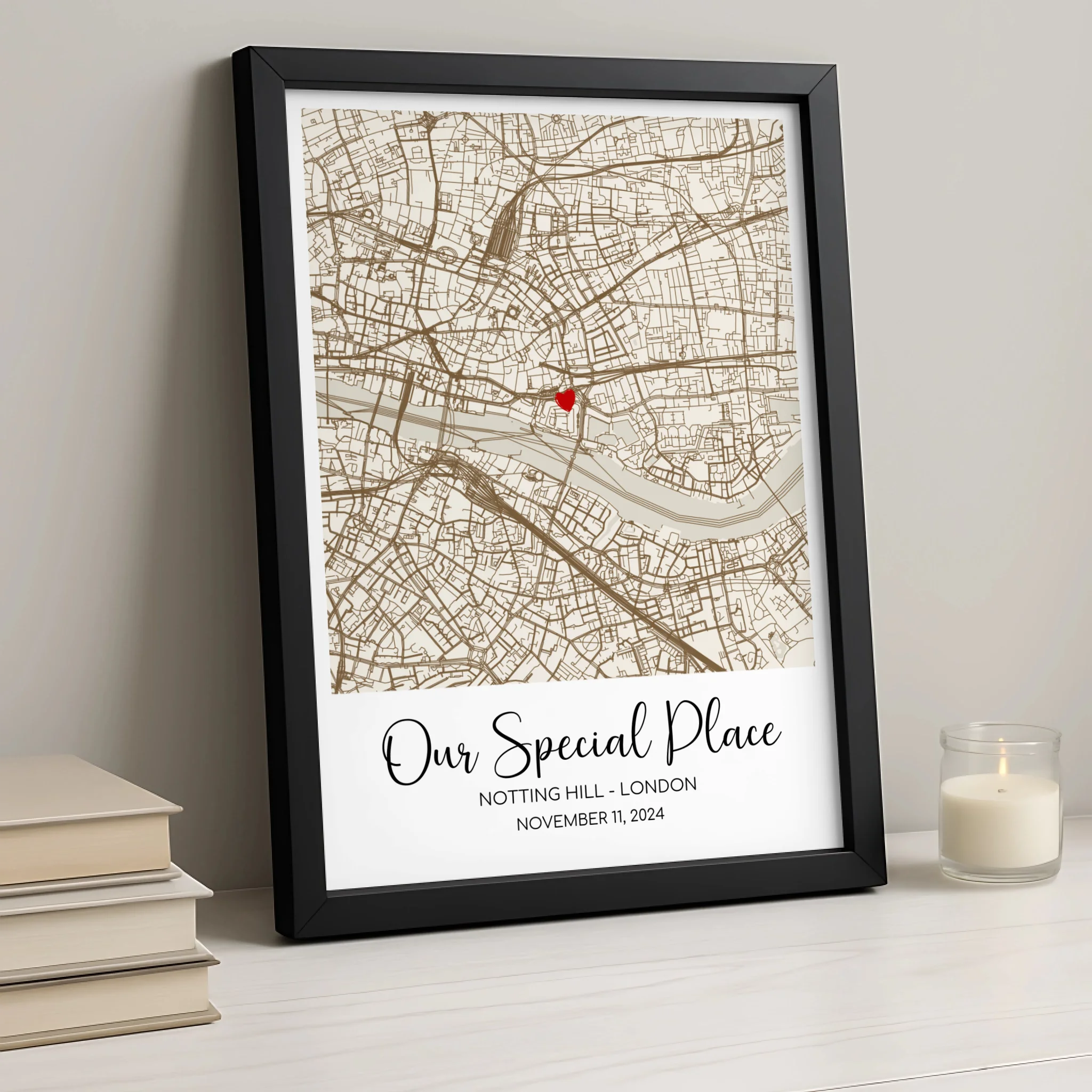 Close-up of personalised map wall art with couples names printed below a heart pin