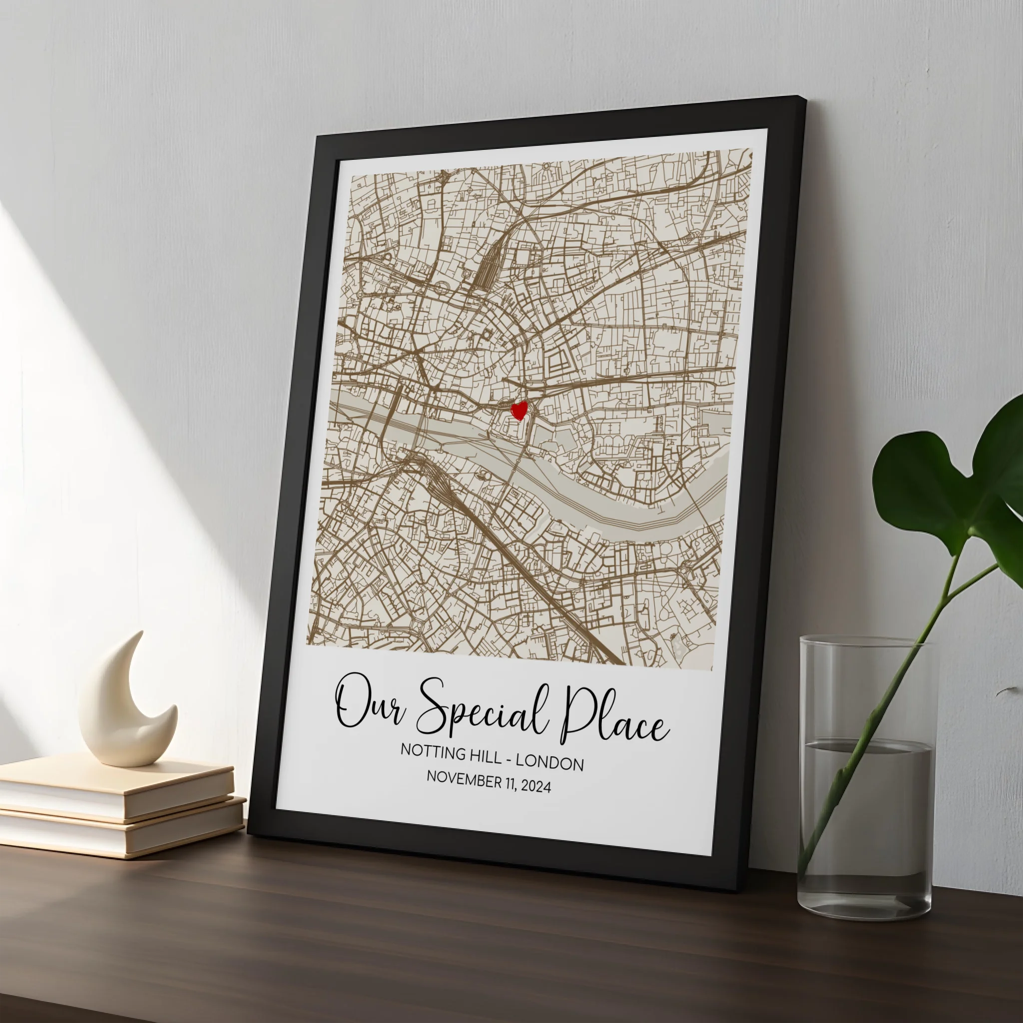 Personalised map print in a black frame with heart marker and custom location text