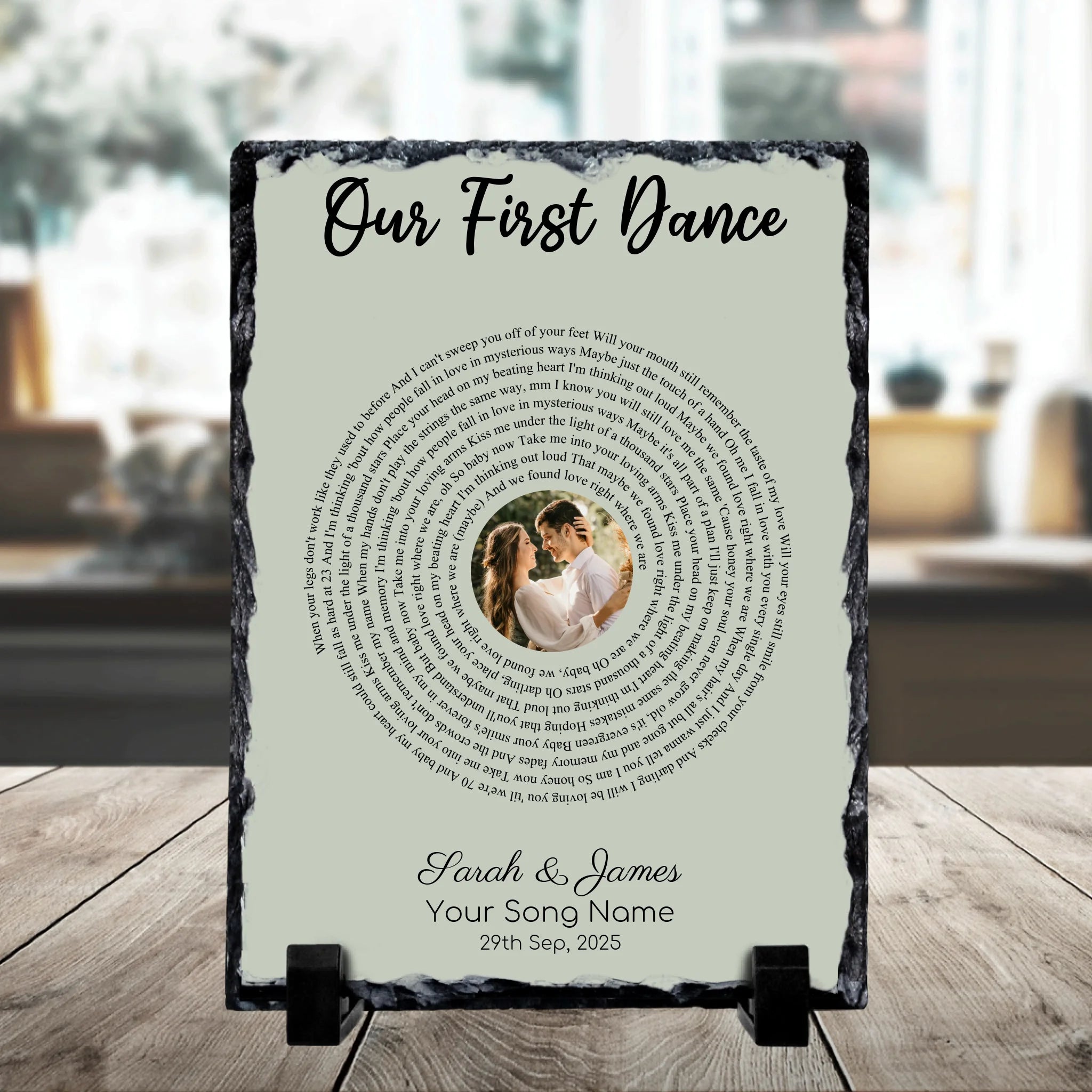 Square personalised slate plaque on a stand reading Our First Dance with spiral song lyrics, a couple's photo, Sarah and Jame