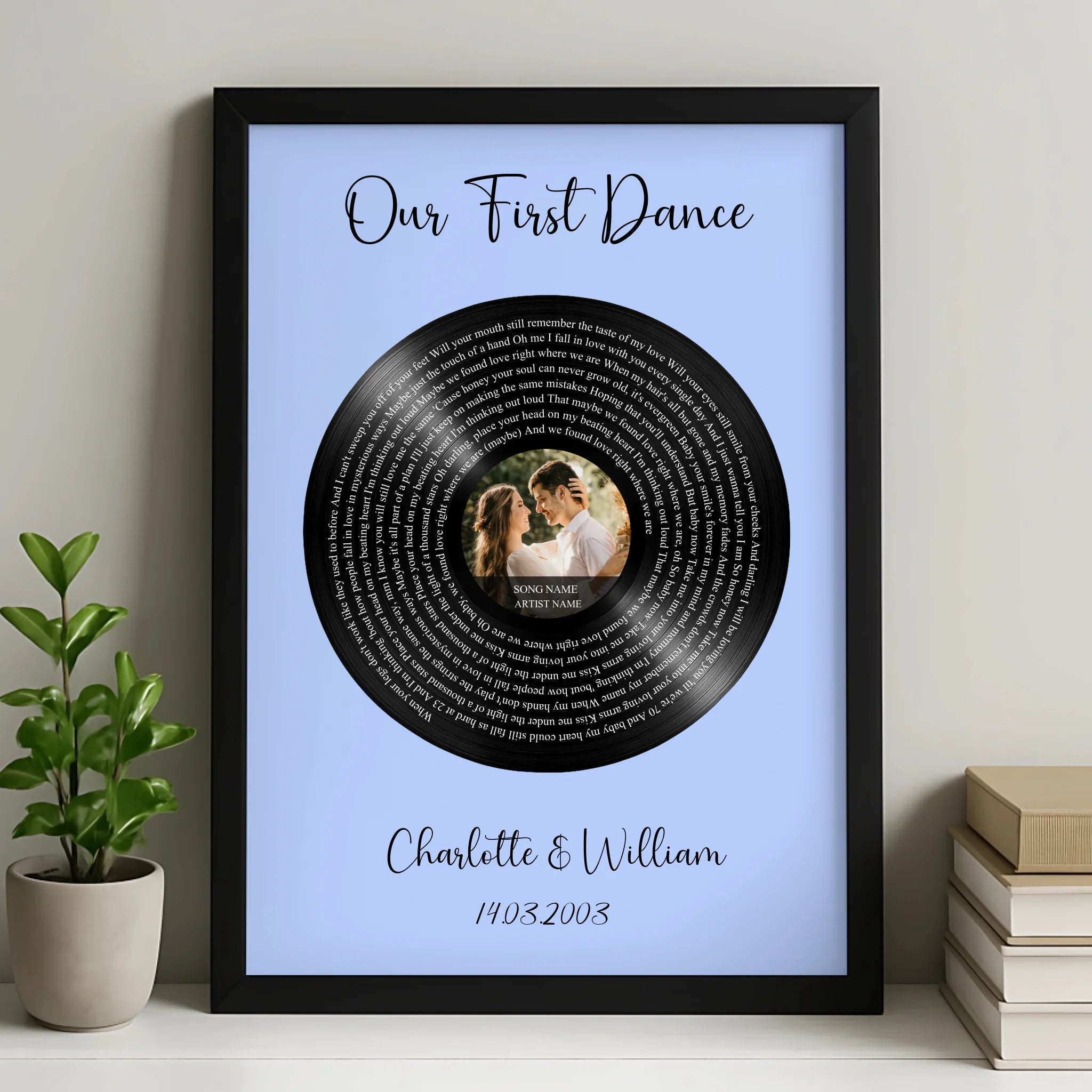 Black framed first dance song lyrics print on blue, vinyl record with couple's photo, Charlotte and William, 14.03.2003, on s