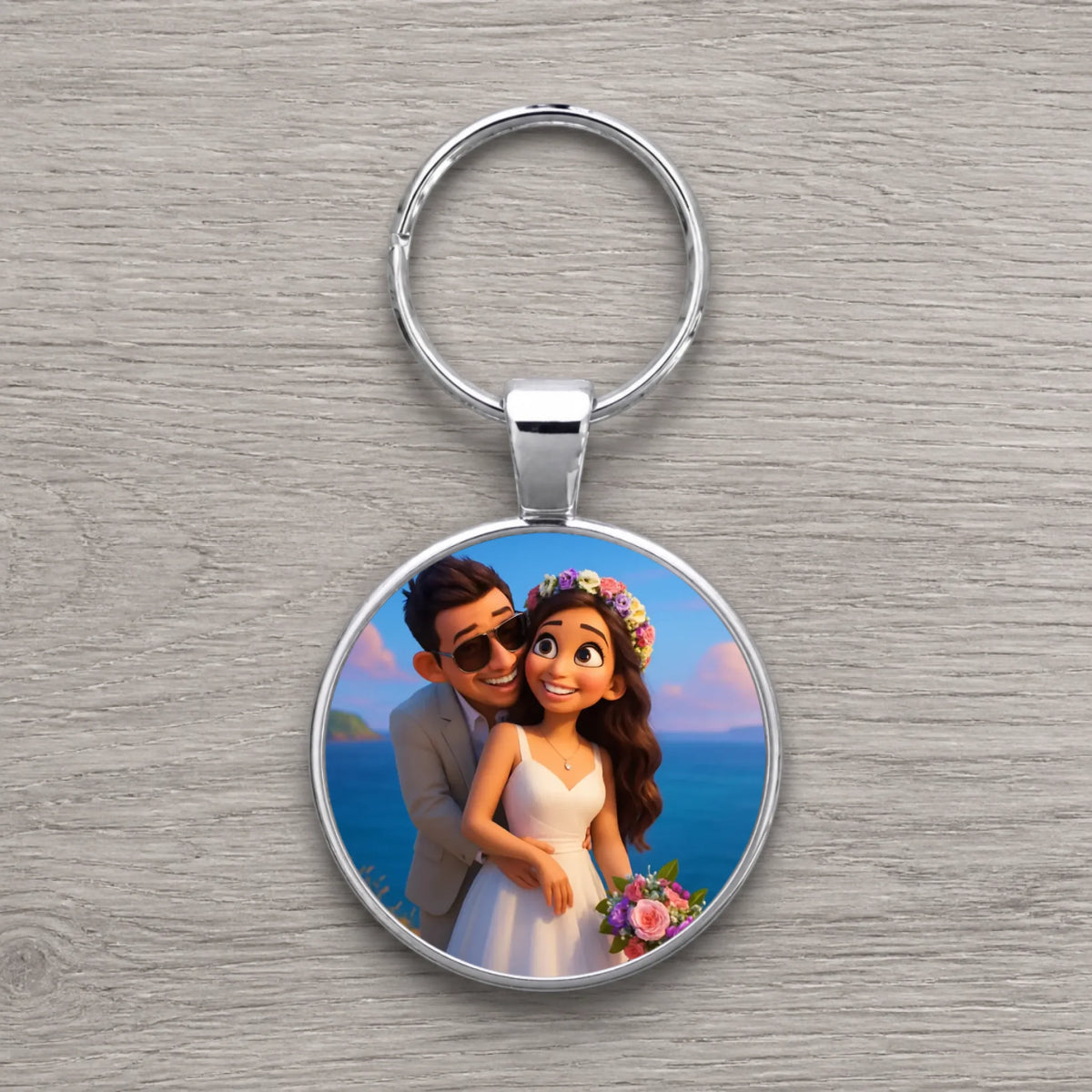 Silver round keyring with cartoon animated bride holding bouquet and groom in sunglasses hugging, ocean backdrop.
